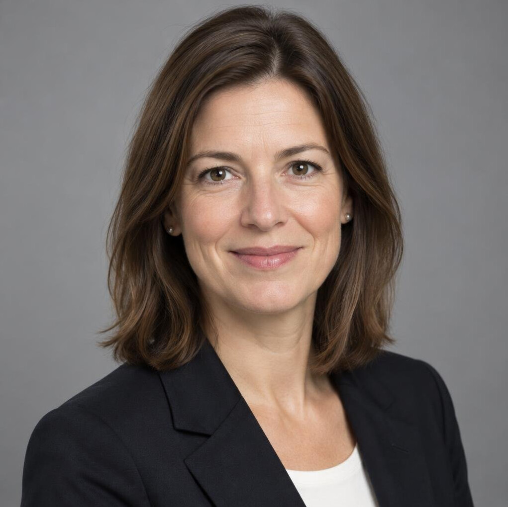 Portrait of a woman with shoulder-length hair in a dark blazer